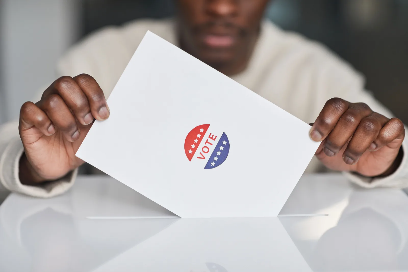 A voter placing a ballot into a box during an election. Focus on the act of voting. Five public survey cases show how small design choices distort estimates