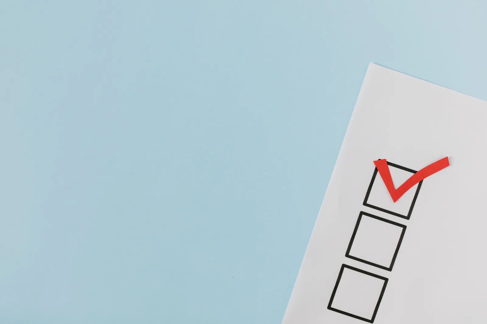 A checklist with a red checkmark symbolizing a completed task on a pastel blue background. Market Research Surveys Checklist: Pass-or-Block Sign-Off