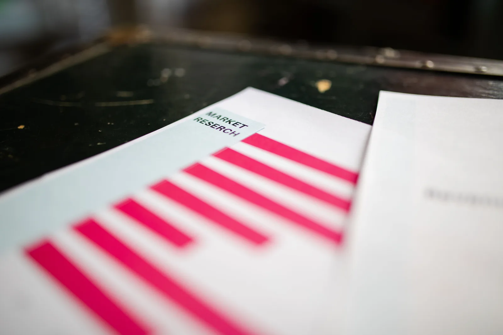A detailed close-up of a market research document featuring a bar graph and a focus on market trends. What fictional secondary market research case studies teach about source judgment and corrections